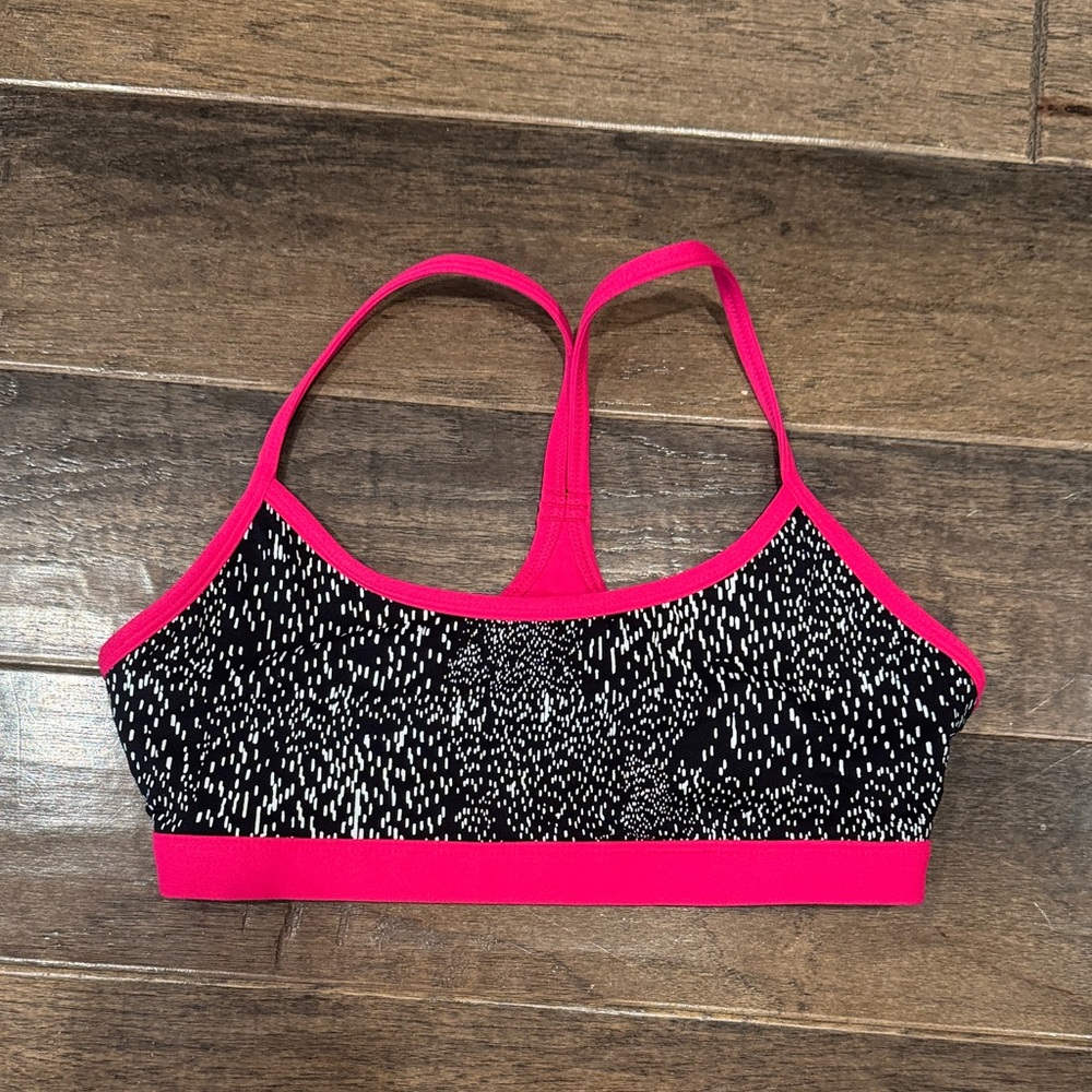 Women's Pink and Black Fabletics sports bra.